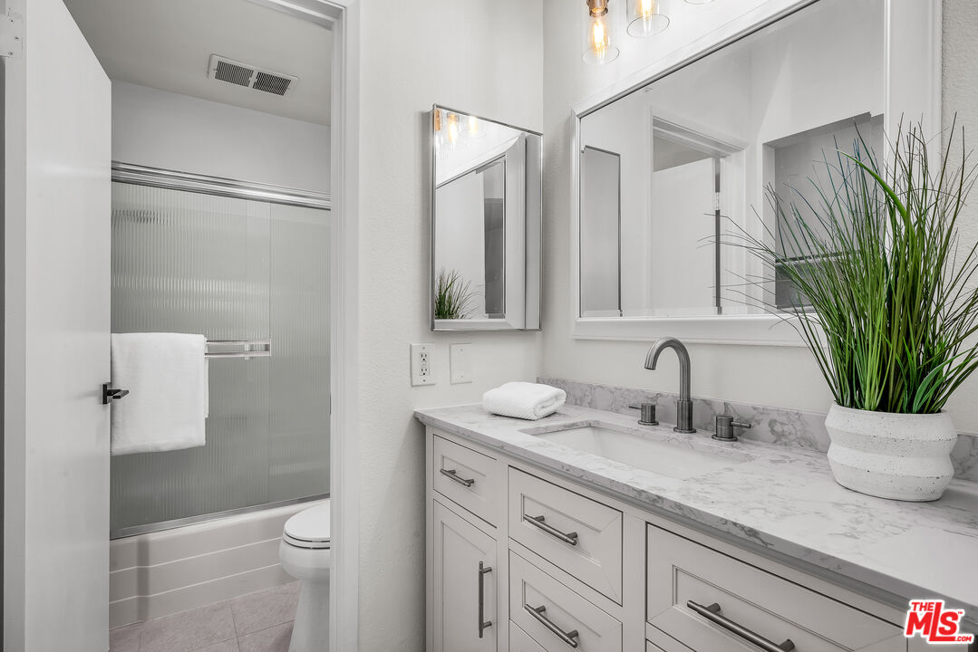 8162 Manitoba Street, Unit 202 Playa del Rey, CA 90293 - Photo 13 of 34 a bathroom with a granite countertop sink toilet and shower