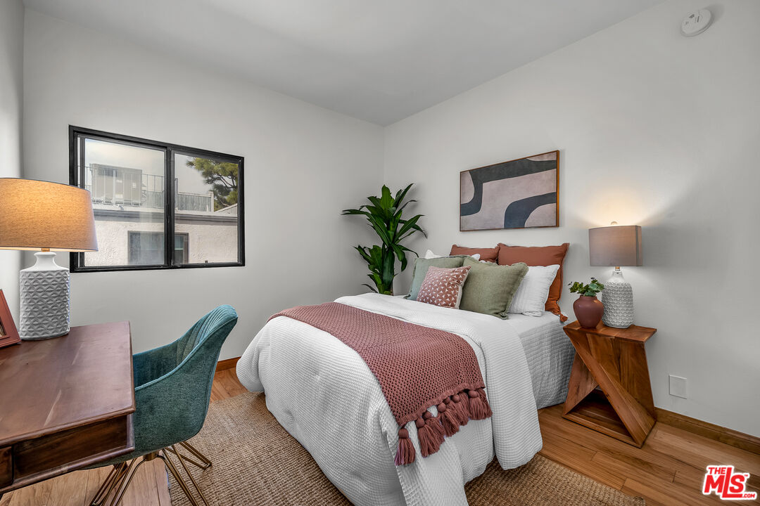 8162 Manitoba Street, Unit 202 Playa del Rey, CA 90293 - Photo 15 of 34 a bed room with a bed and a chair