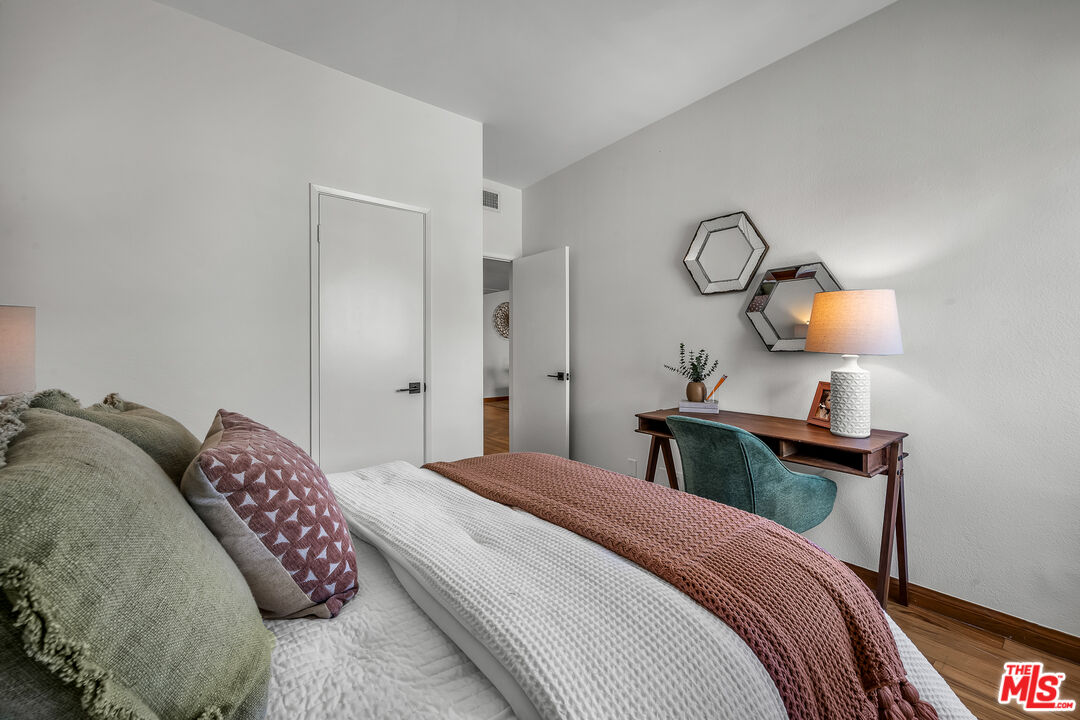 8162 Manitoba Street, Unit 202 Playa del Rey, CA 90293 - Photo 16 of 34 a bedroom with a bed and a chandelier
