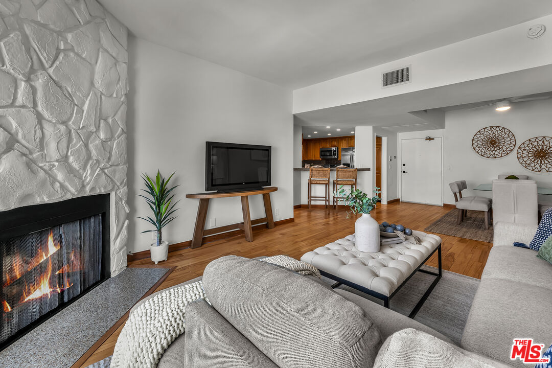 8162 Manitoba Street, Unit 202 Playa del Rey, CA 90293 - Photo 5 of 34 a living room with furniture a fireplace and a flat screen tv