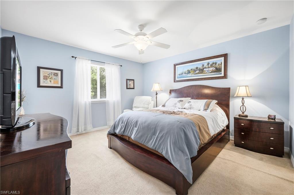3916 Cherrybrook Loop Fort Myers, FL 33966 - Photo 13 of 31 Room featuring a ceiling fan with integrated lighting, a window with horizontal blinds and sheer curtains, light-colored carpeting, and light blue wall tones