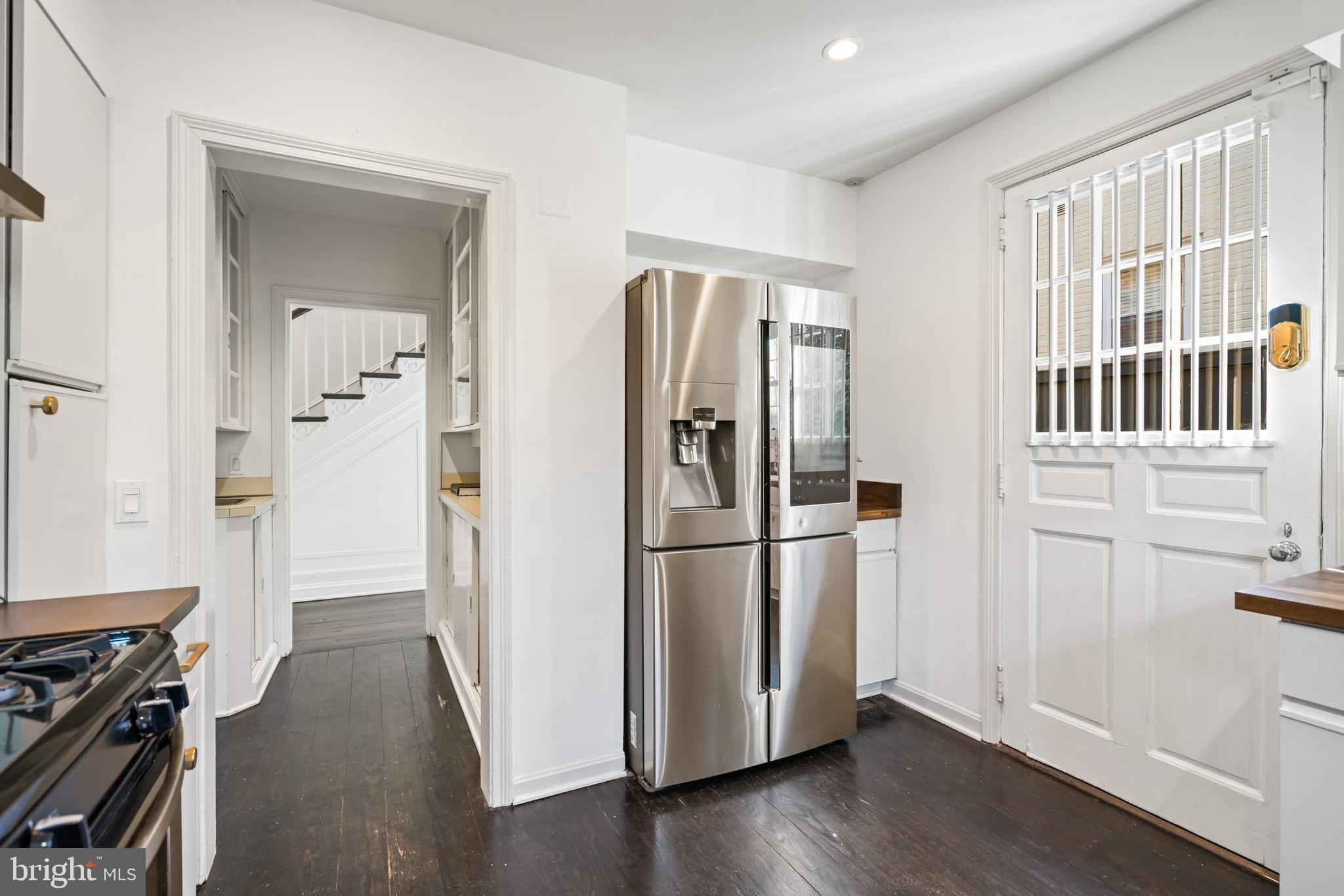 1698 32nd Street Northwest Washington, DC 20007 - Photo 11 of 29 a view of a kitchen with a refrigerator a stove top oven and hallway