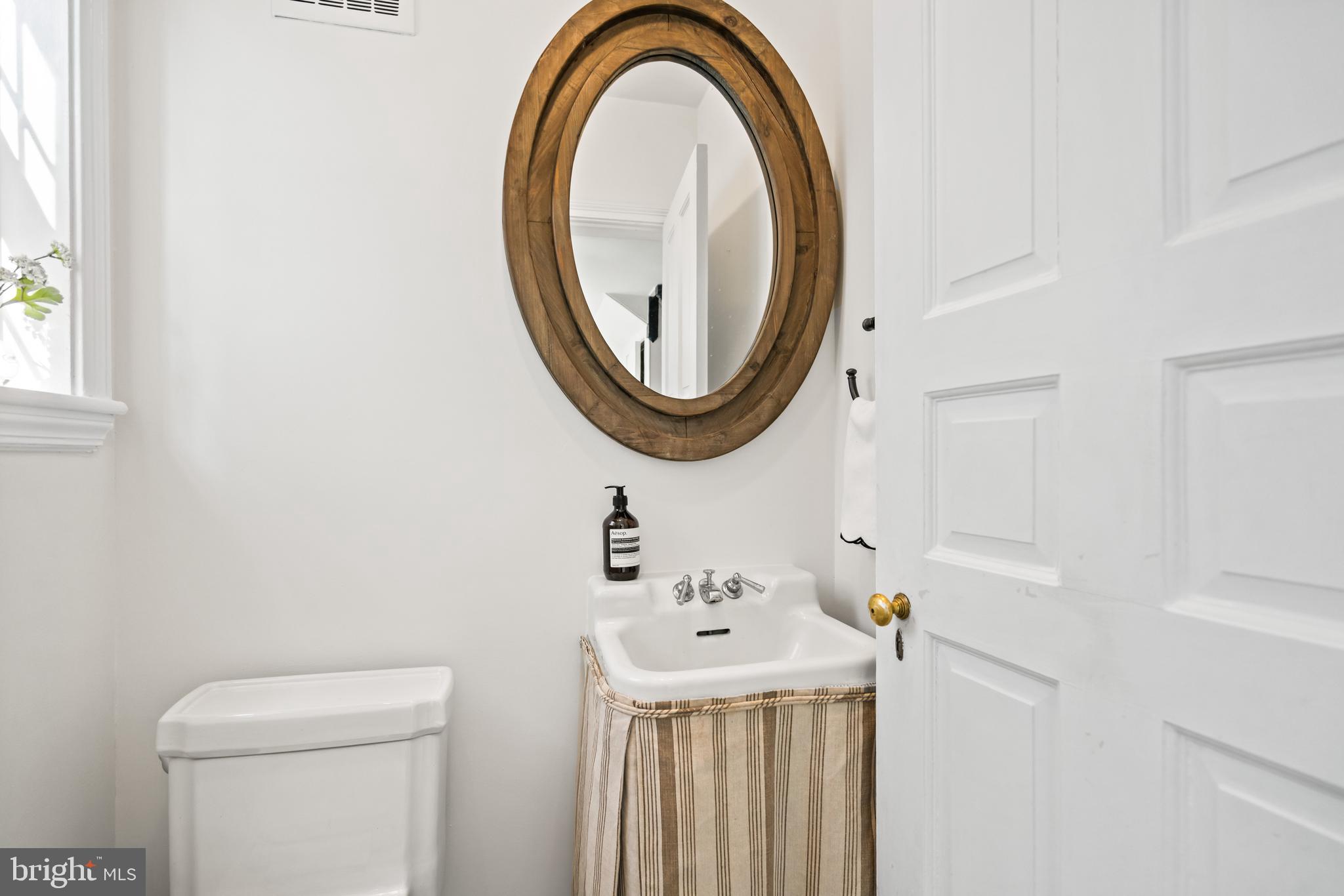 1698 32nd Street Northwest Washington, DC 20007 - Photo 13 of 29 a bathroom with a sink and a mirror