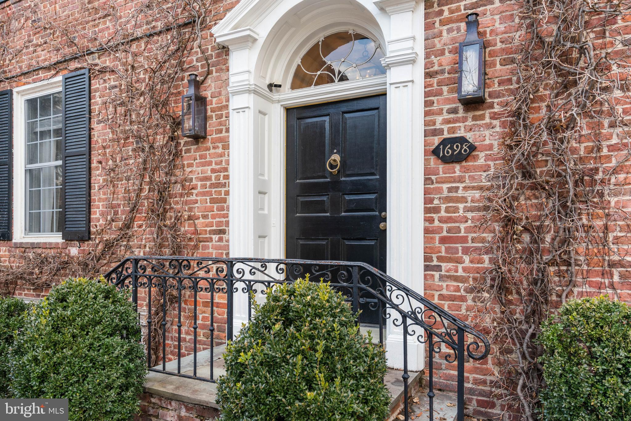 1698 32nd Street Northwest Washington, DC 20007 - Photo 2 of 29 front view of a brick house with a small yard