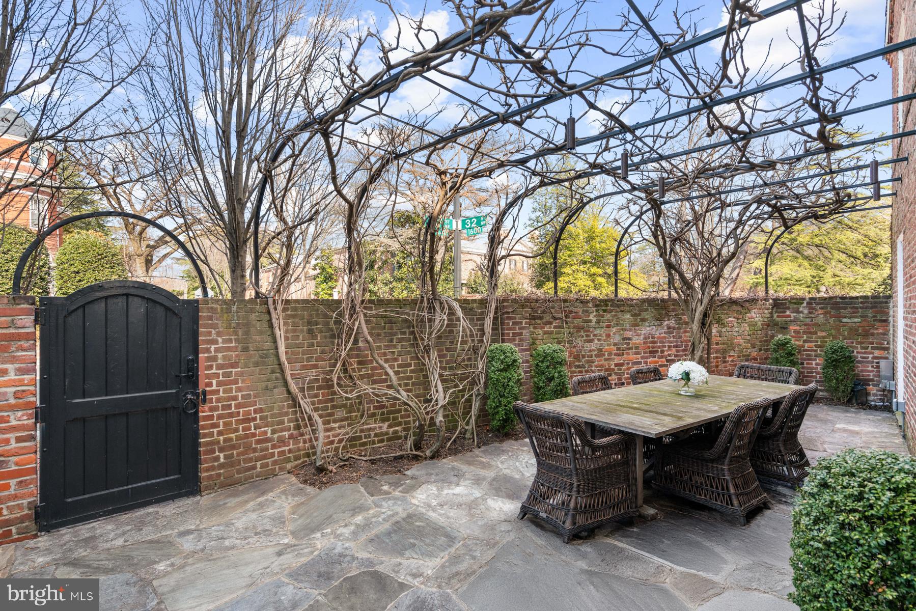 1698 32nd Street Northwest Washington, DC 20007 - Photo 23 of 29 a backyard of a house with table and chairs