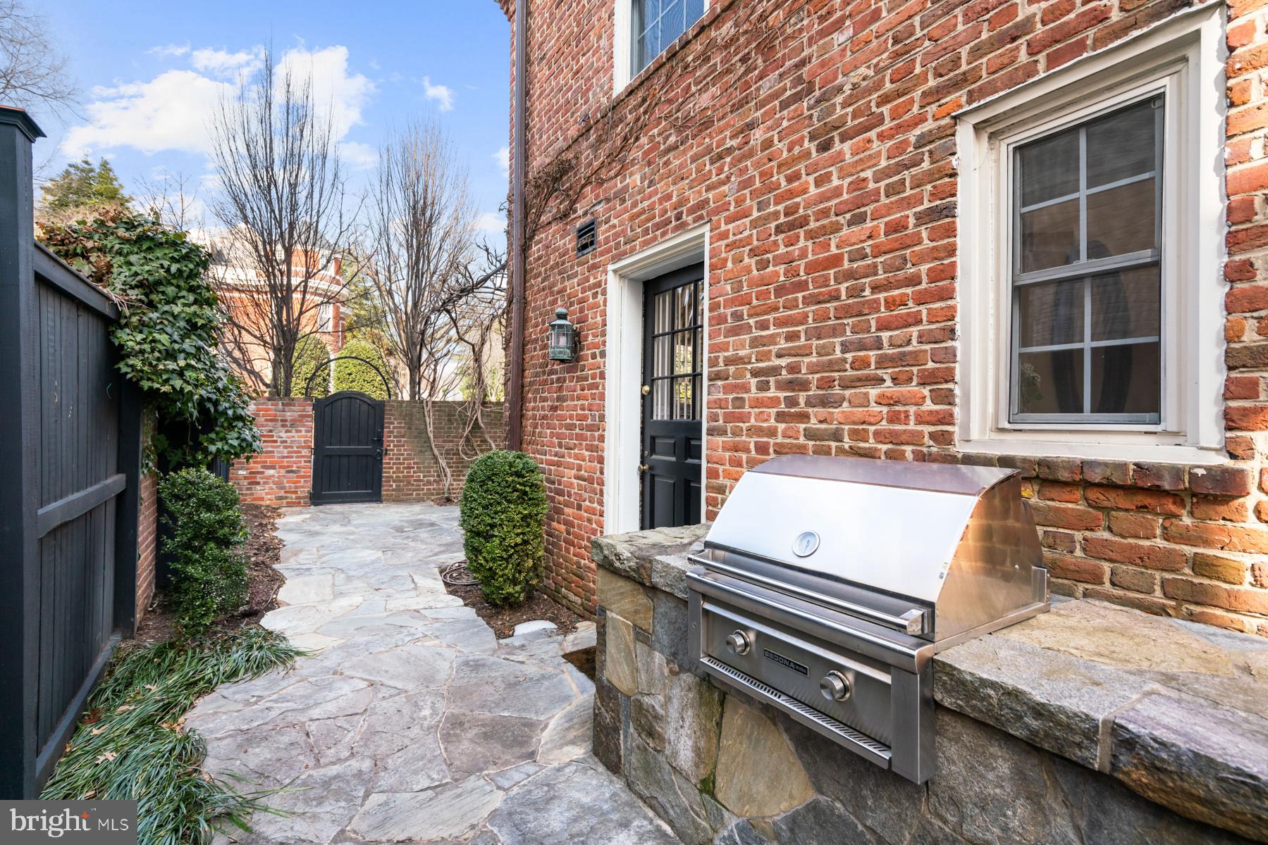 1698 32nd Street Northwest Washington, DC 20007 - Photo 25 of 29 a view of a patio with a table and chairs and potted plants