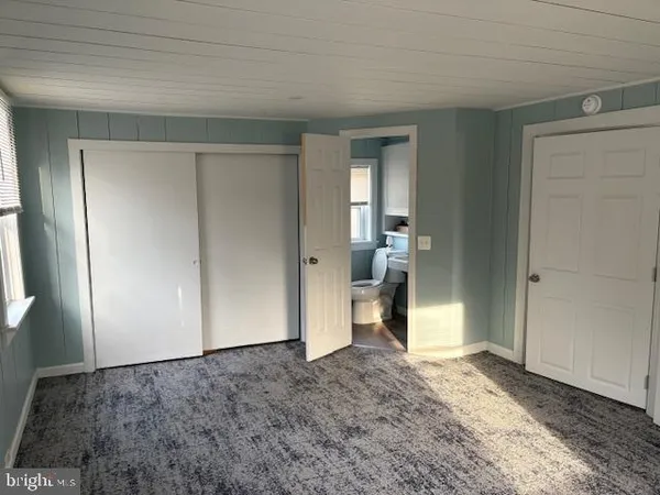 a view of a big room with closet and wooden floor