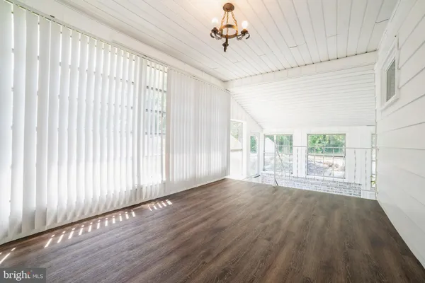 a view of wooden floor and windows in a room