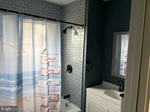 a bathroom with a bathtub and shower