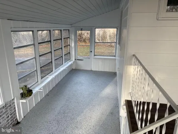 a view of an entryway with wooden floor