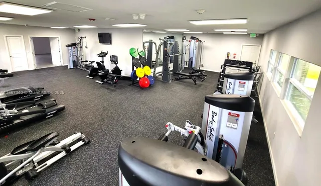 a view of a livingroom with workspace and a window
