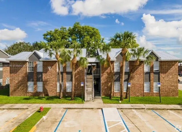 a front view of a residential houses with yard