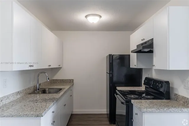 a kitchen that has a sink and a stove