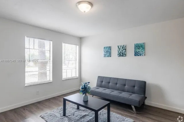 a living room with furniture and a window