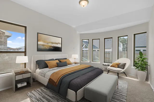 a bedroom with a bed and glass windows