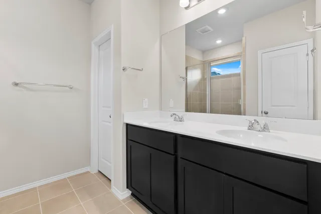 a bathroom with a double vanity sink and mirror
