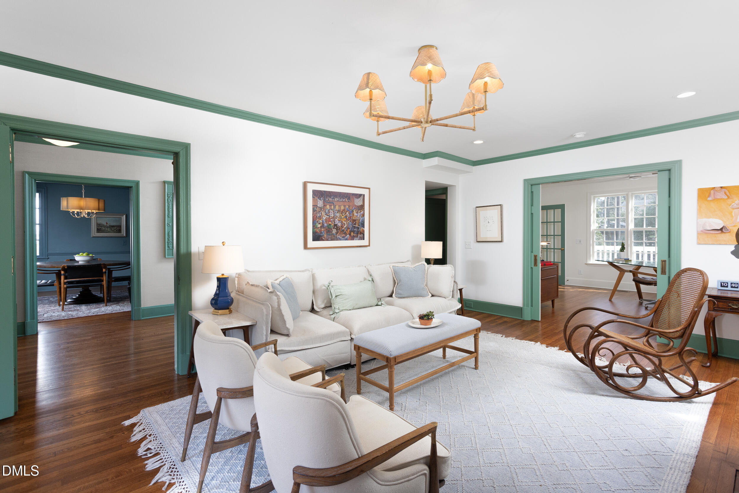 3433 Dover Road Durham, NC 27707 - Photo 22 of 56 a living room with furniture a dining table and a chandelier