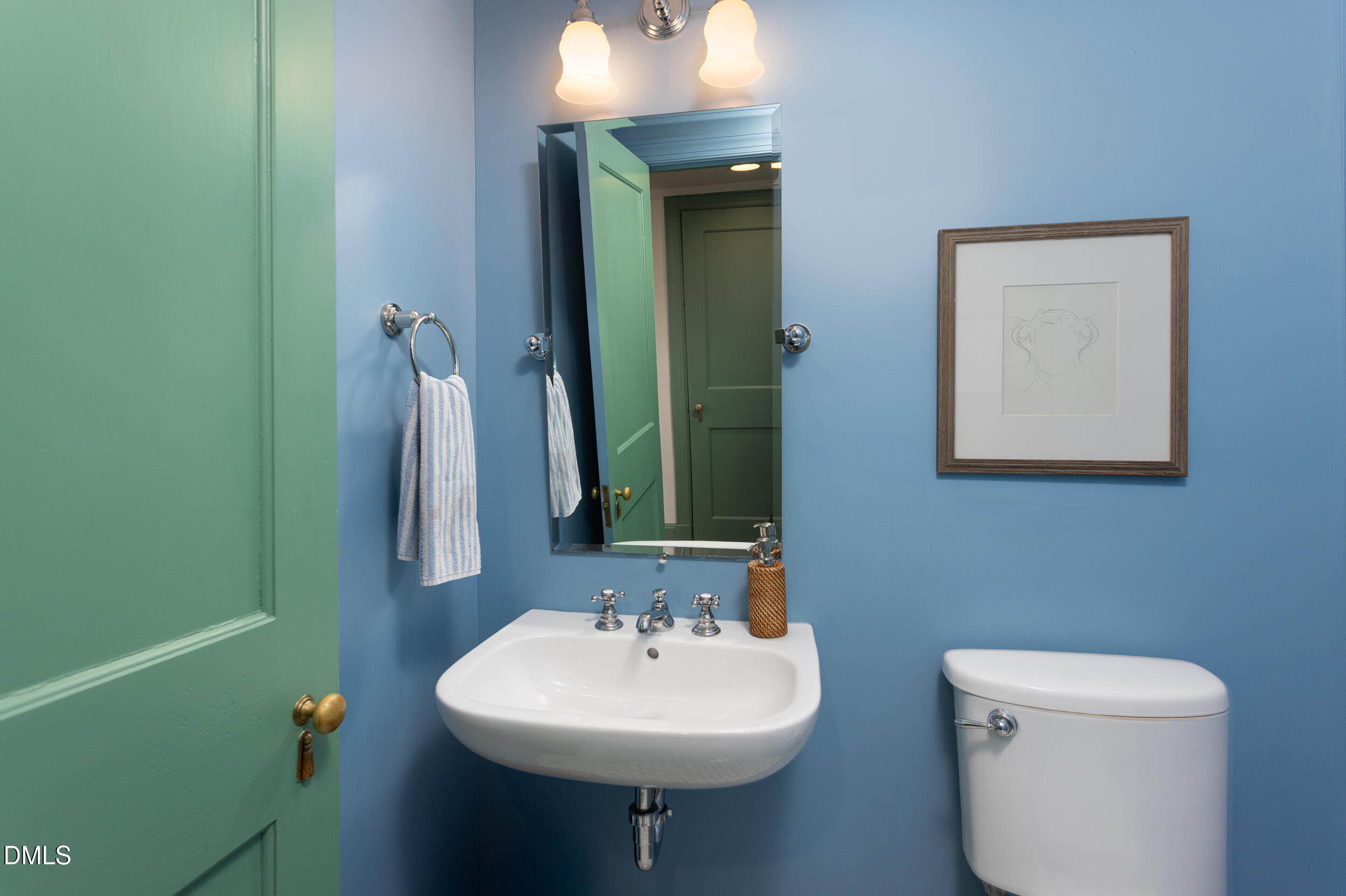 3433 Dover Road Durham, NC 27707 - Photo 41 of 56 a bathroom with a toilet sink and mirror