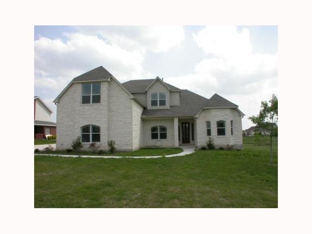 a black and white house with a yard