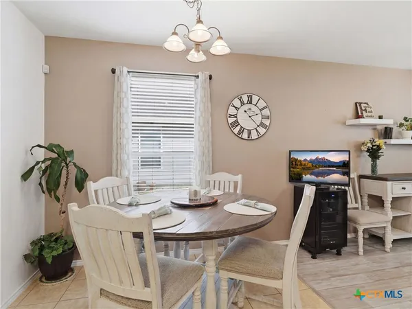 a view of a dining room with furniture wooden floor and a chandelier
