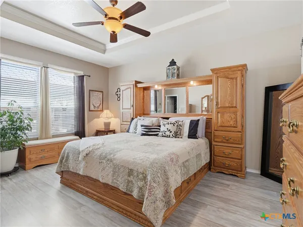 a bedroom with a bed and a chandelier