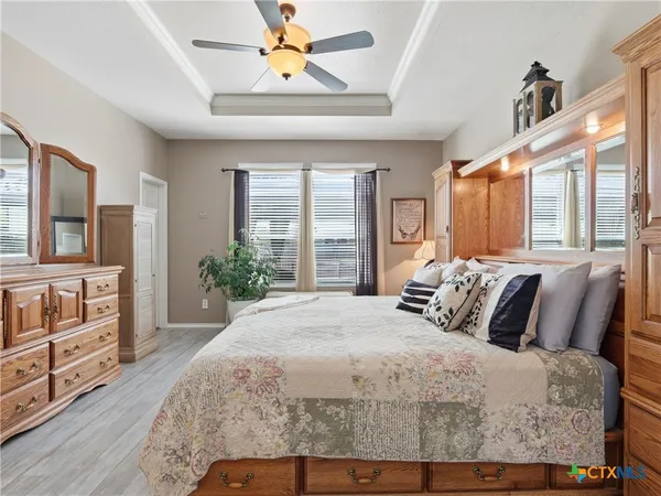 a bedroom with a large bed and a window