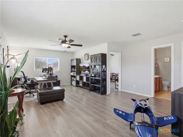 a living room with furniture and a gym equipment