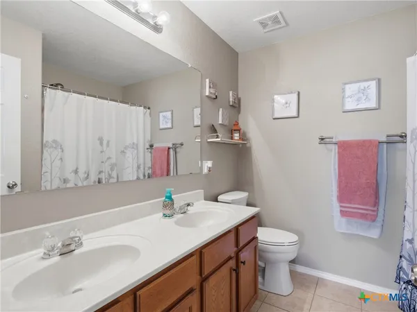 a bathroom with a sink toilet and a mirror