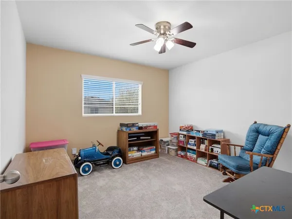 a view of a room with furniture and a window