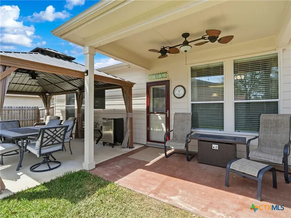 a view of a chairs and table in a patio