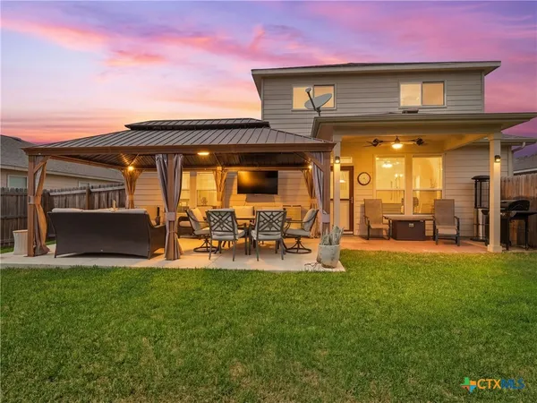 a front view of a house with patio and garden