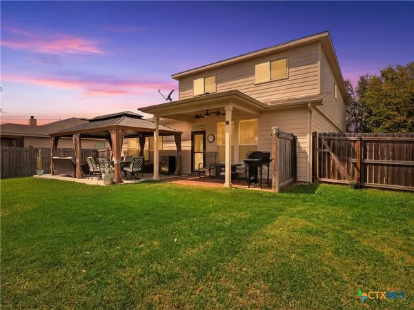 a view of a house with a yard and sitting area
