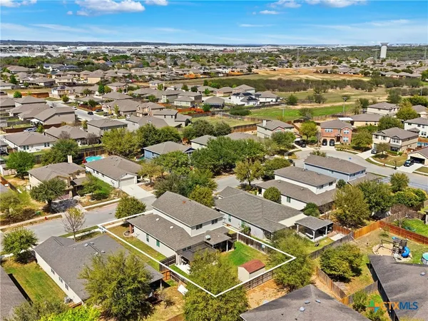 an aerial view of residential houses with outdoor space
