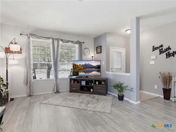 a living room with furniture and wooden floor