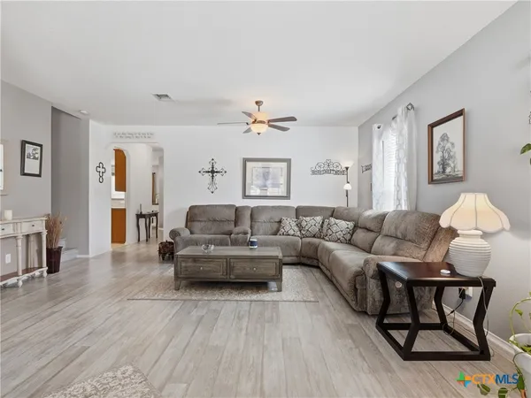 a living room with furniture and wooden floor