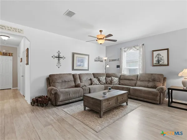a living room with furniture and a wooden floor