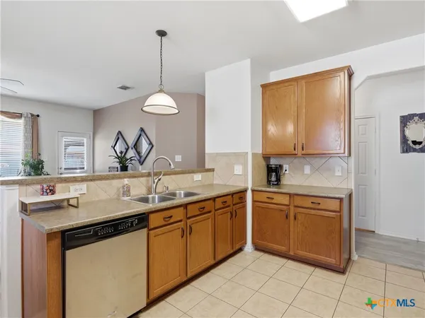 a kitchen with a sink and cabinets