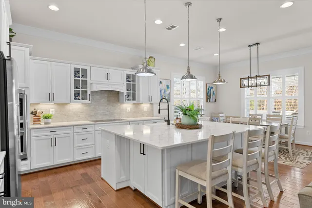 a kitchen with stainless steel appliances granite countertop a stove top oven a sink a counter space and cabinets