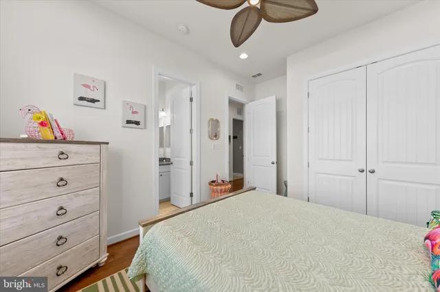 a bathroom with a granite countertop sink mirror vanity and a toilet