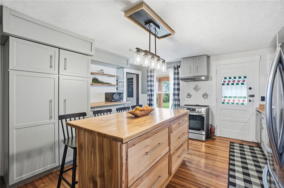 6155 North Union Road Clayton, OH 45315 - Photo 19 of 59 This charming kitchen offers abundant natural light and features a spacious wood island.