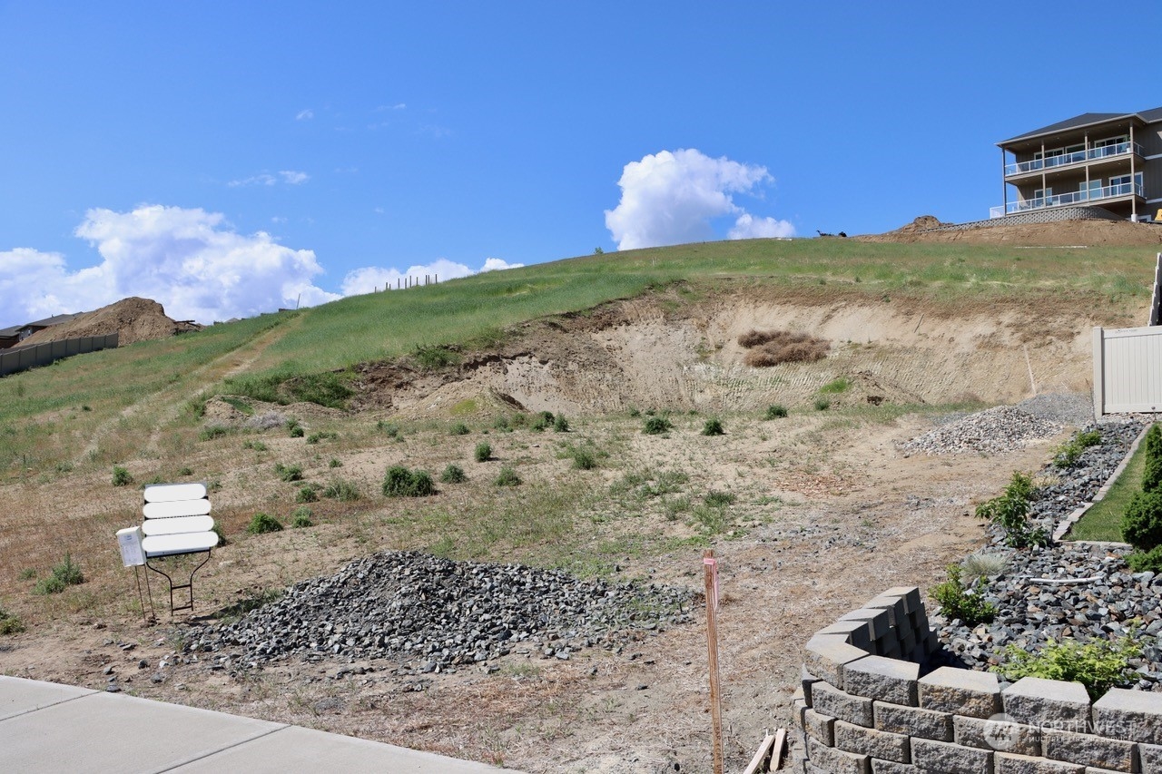 91 Sunny Meadows Loop Wenatchee, WA 98801 - Photo 2 of 17 a view of a yard with mountain and wooden fence