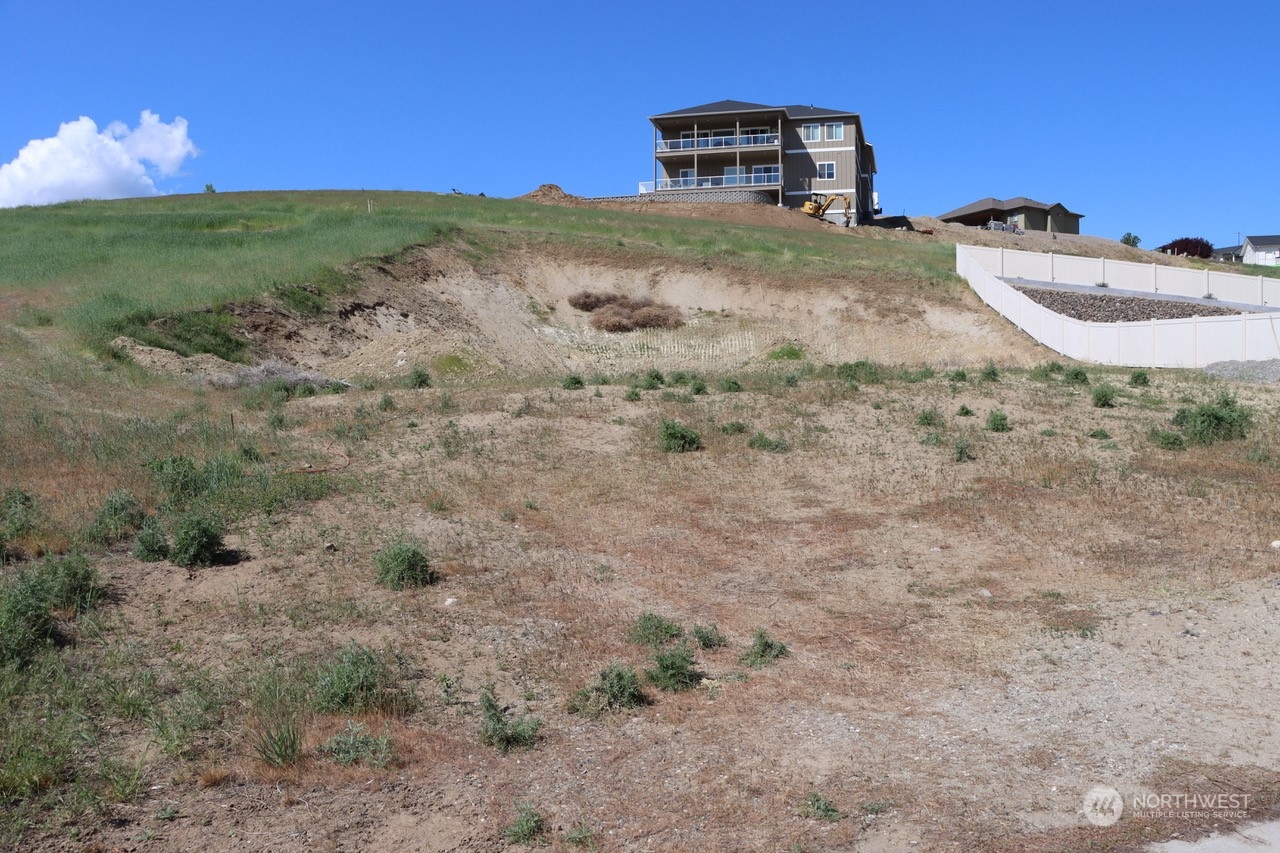 91 Sunny Meadows Loop Wenatchee, WA 98801 - Photo 3 of 17 a view of a backyard with plants and wooden fence