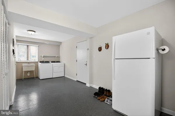 a kitchen with a refrigerator a sink and cabinets