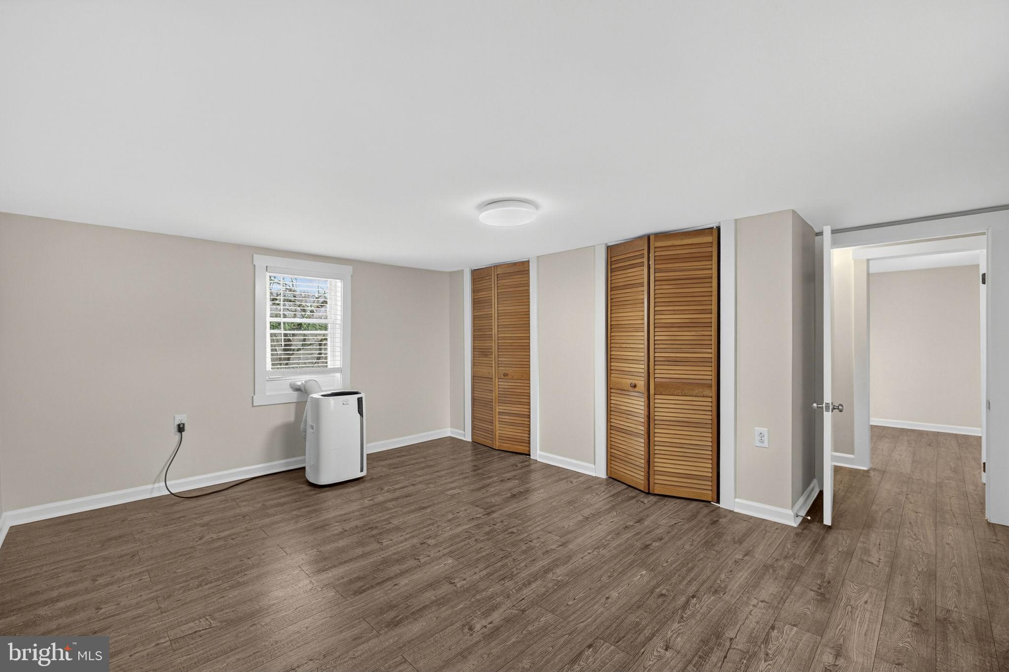 239 McDonald Road Winchester, VA 22602 - Photo 14 of 20 a view of an empty room with a window and wooden floor