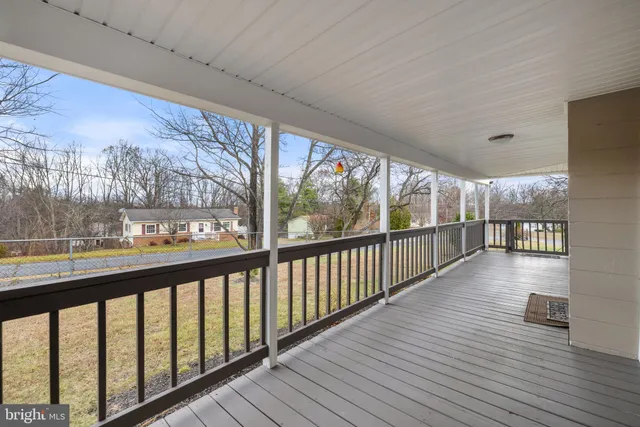 a view of a house with a yard and large trees