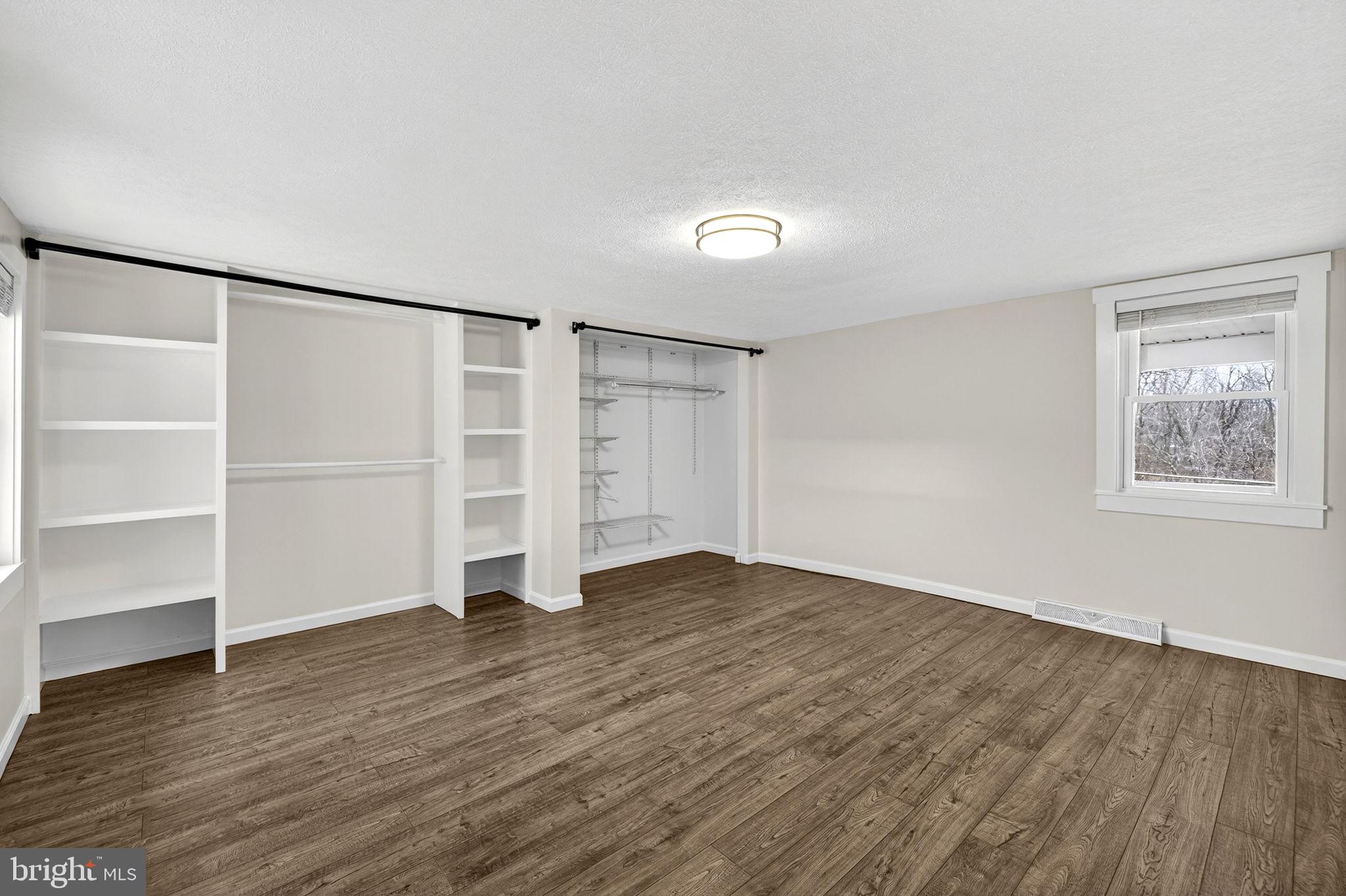 239 McDonald Road Winchester, VA 22602 - Photo 9 of 20 a view of an empty room with a window and wooden floor