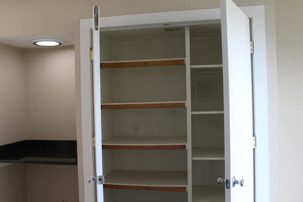 a view of walk in closet with empty racks