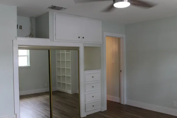 a view of cabinets and wooden floor