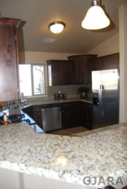 167 Red Rocks Street Fruita, CO 81521 - Photo 5 of 9 a kitchen with granite countertop a refrigerator and a sink
