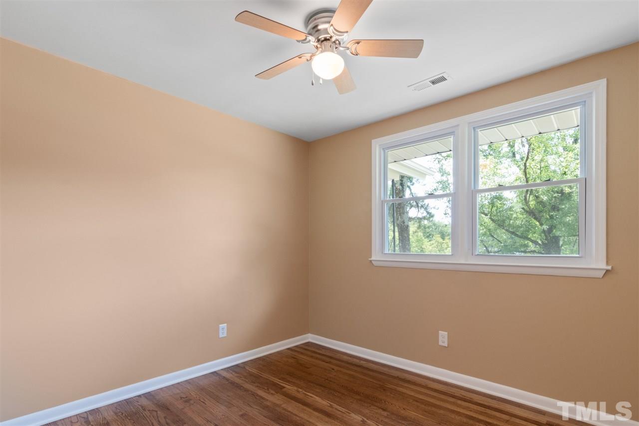 701 Hadley Road Raleigh, NC 27610 - Photo 12 of 16 an empty room with a window and a fan